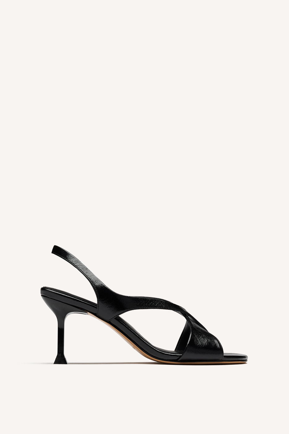 Nelson Made black leather slingback sandal with a slim set back high heel, shown in profile against a solid off-white background.