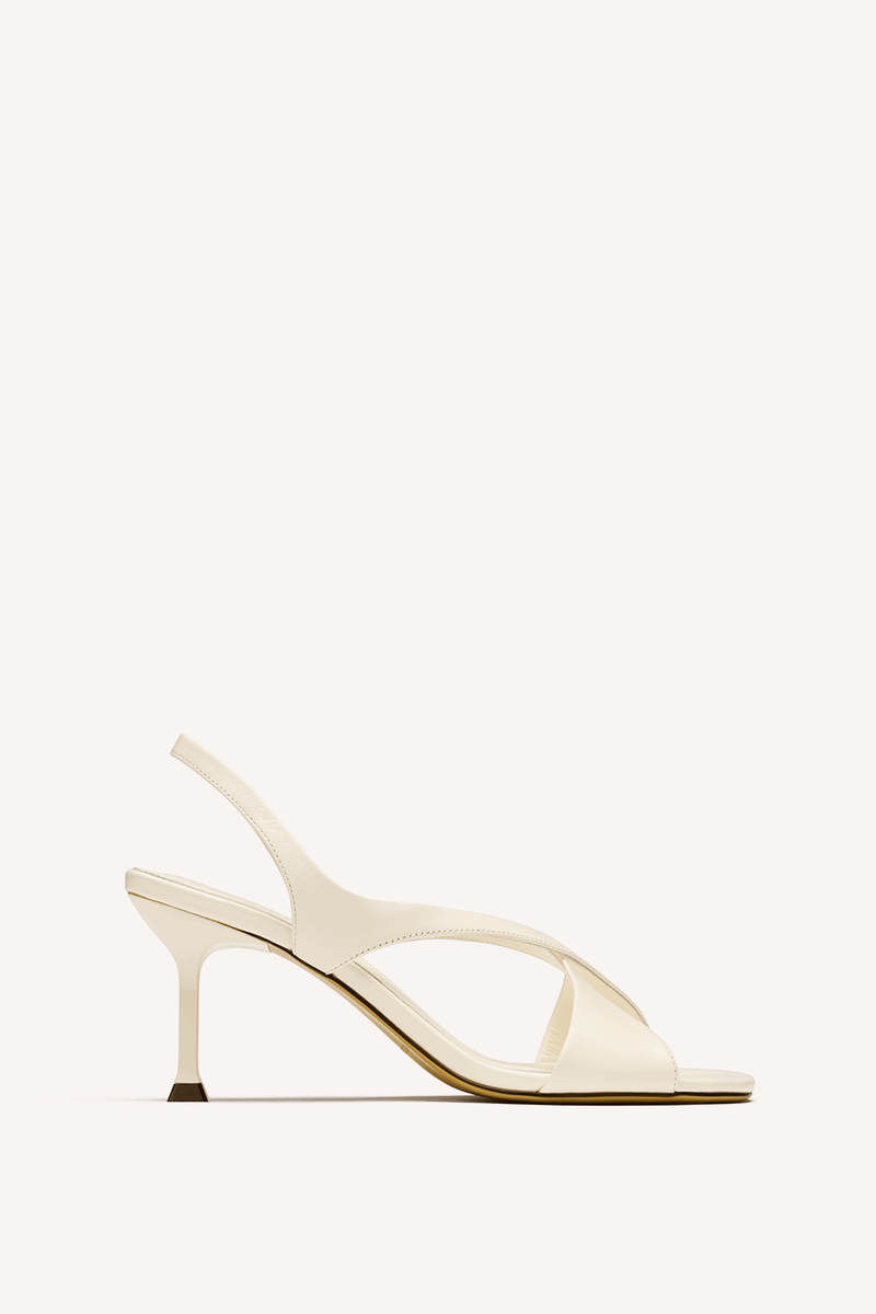 Nelson Made cream leather slingback sandal with a slim set back high heel, shown in profile against a solid off-white background.