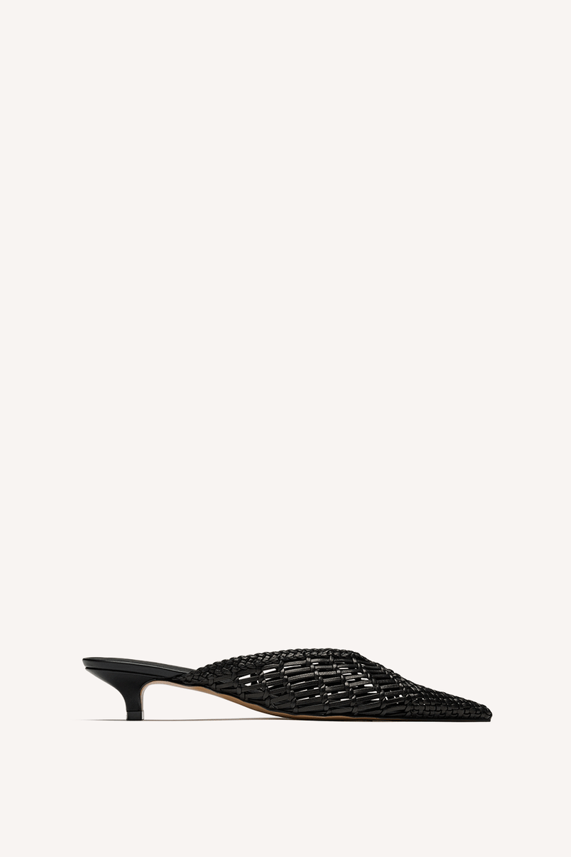 Nelson Made black woven mule with a pointed toe and kitten heel, shown in profile against a solid off-white background.