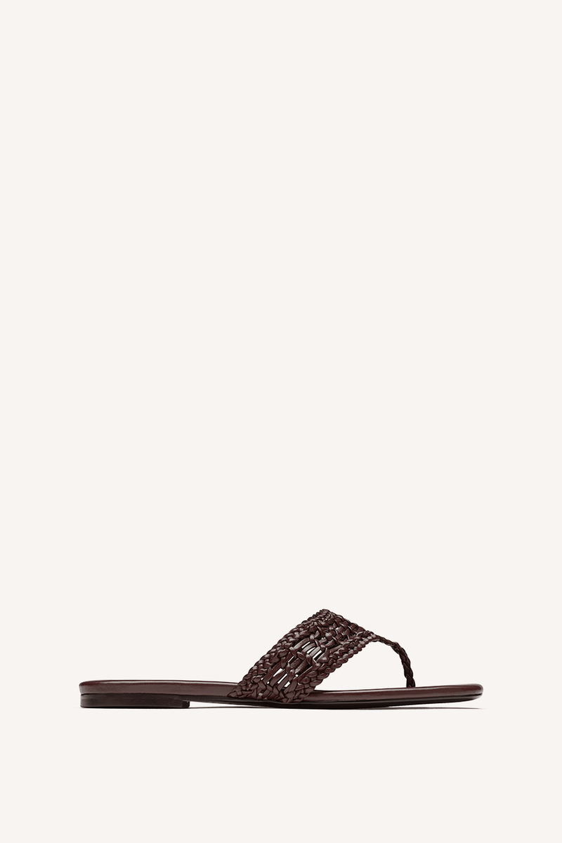 Nelson Made chocolate woven thong sandal with a flat sole, shown in profile against a solid off-white background.