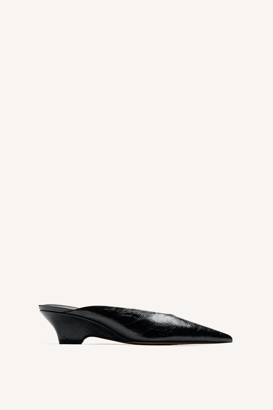 Nelson Made black leather point toe mule slipper with a low wedge, shown in profile against a solid off-white background.