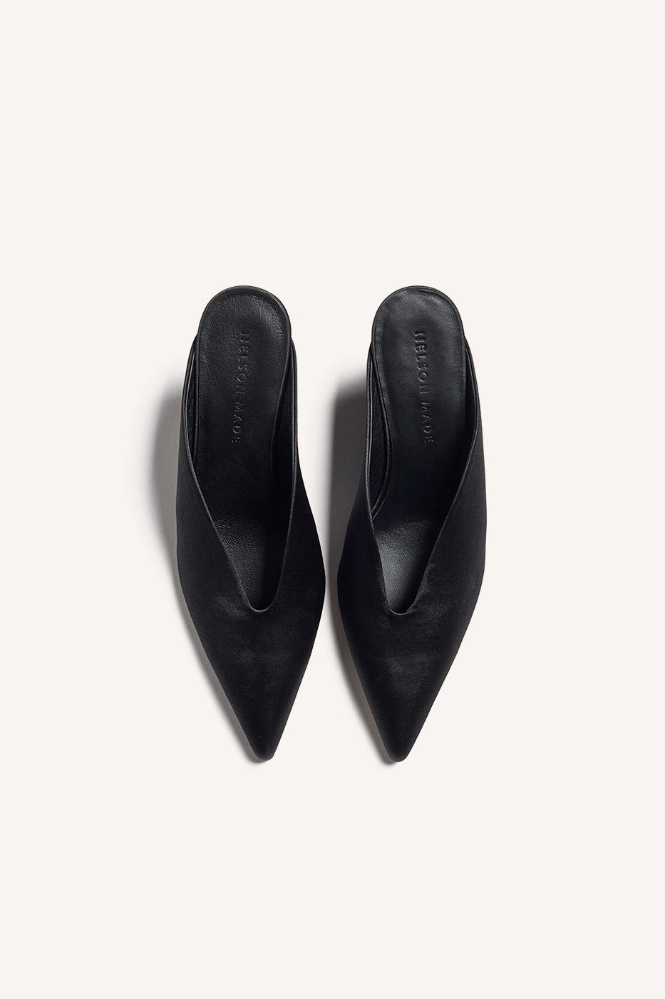 Nelson Made black satin point toe mule slipper with a low wedge, shown from top angle against a solid off-white background.