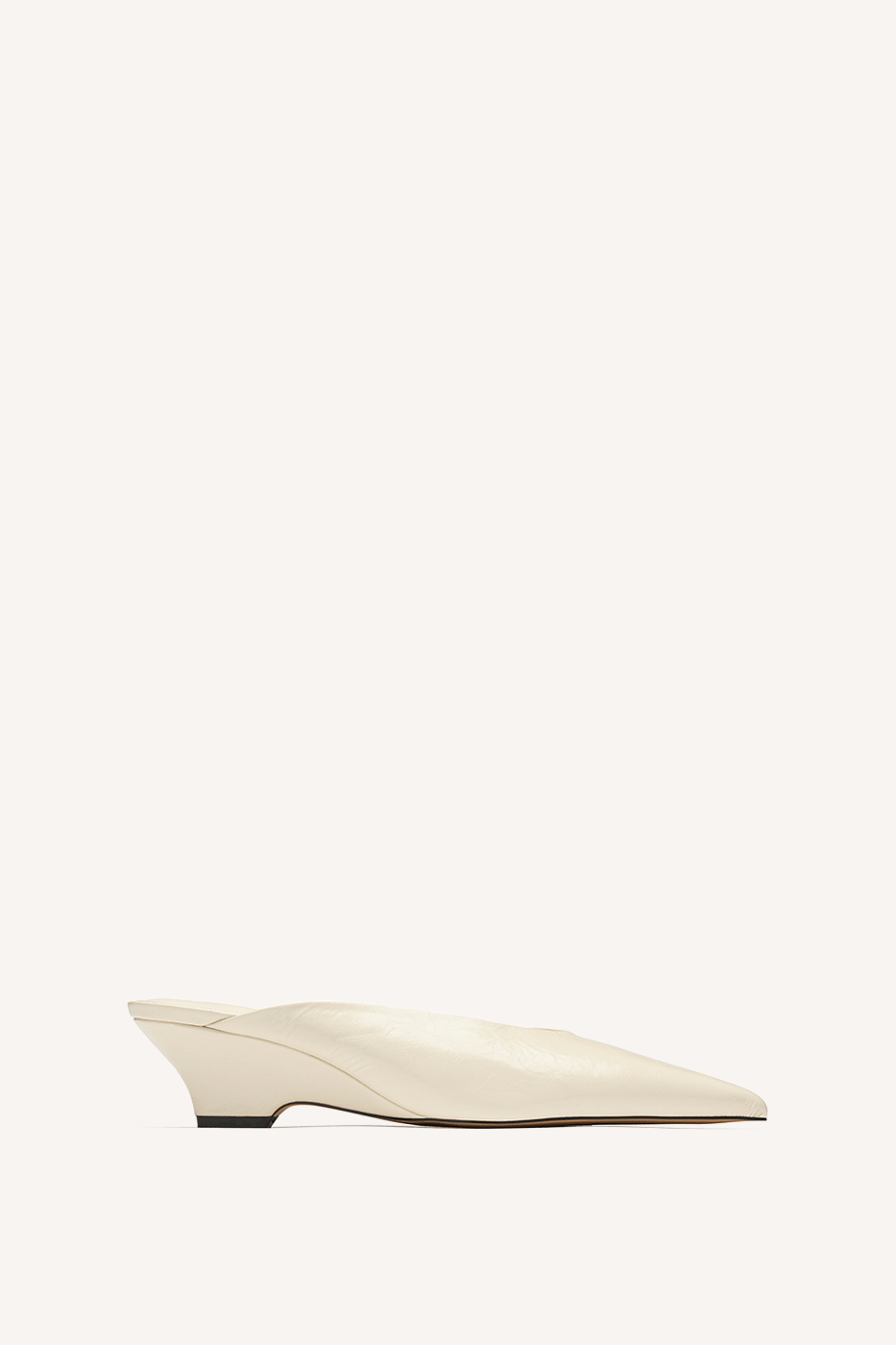 Nelson Made cream leather point toe mule slipper with a low wedge, shown in profile against a solid off-white background.