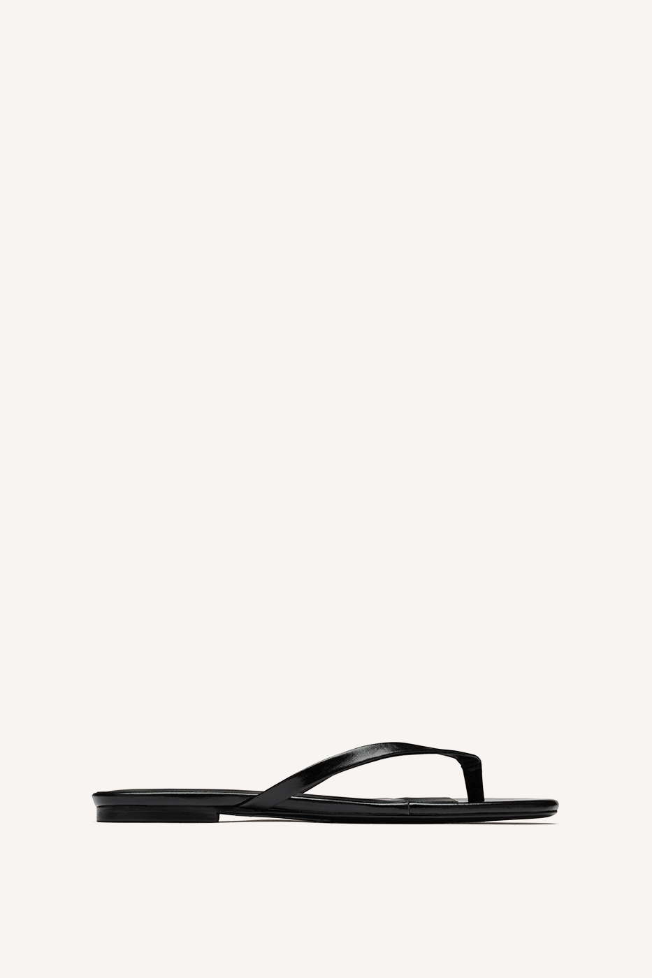 Nelson Made black leather thong sandal with a flat sole, shown in profile against a solid off-white background.