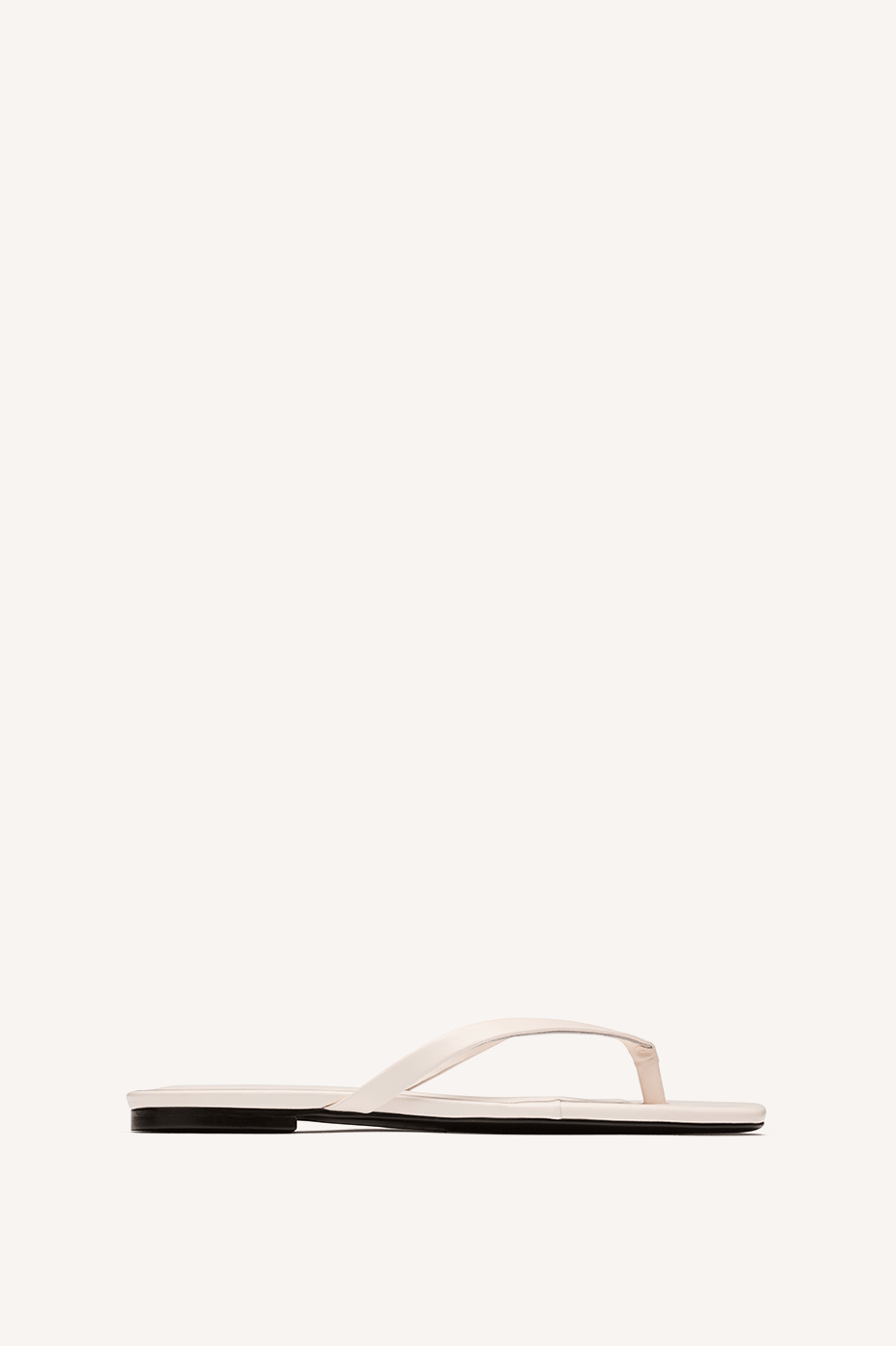 Nelson Made cream leather thong sandal with a flat sole, shown in profile against a solid off-white background.