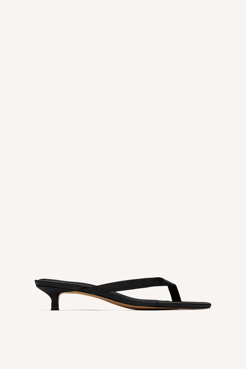 Nelson Made black thong sandal with a low kitten heel and a thin strap, shown in profile against a solid off-white background.