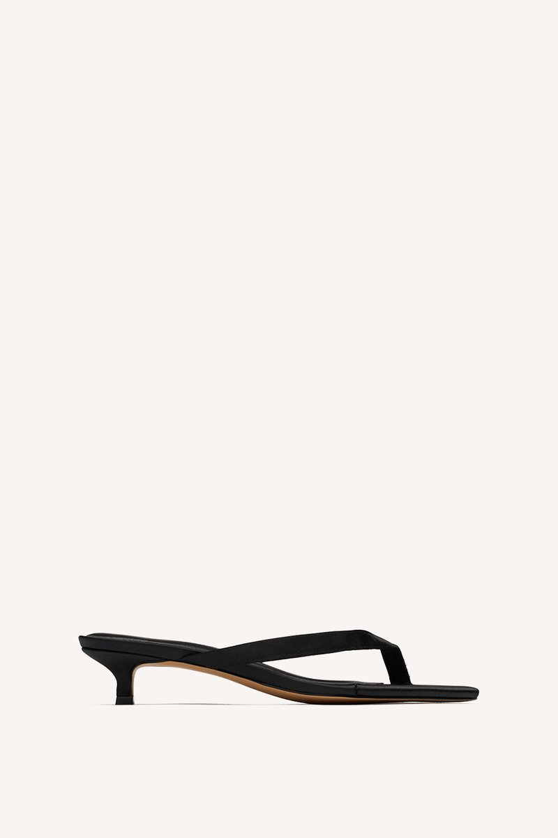 Nelson Made black thong sandal with a low kitten heel and a thin strap, shown in profile against a solid off-white background.